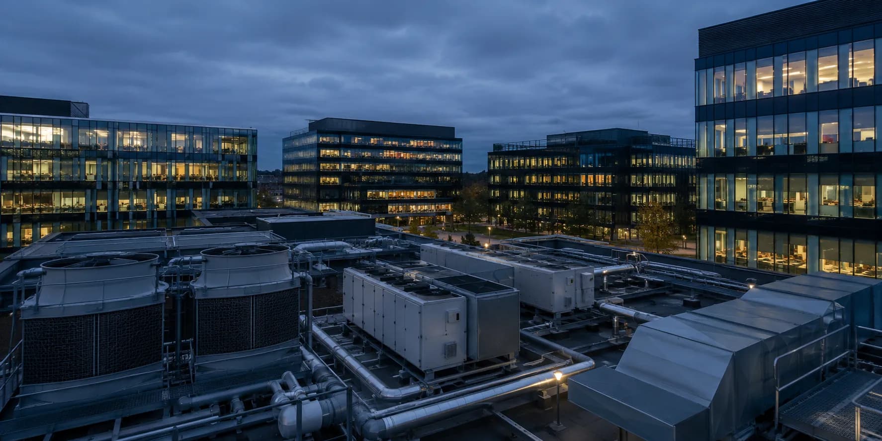 Rooftop HVAC plant serving modern commercial buildings at dusk